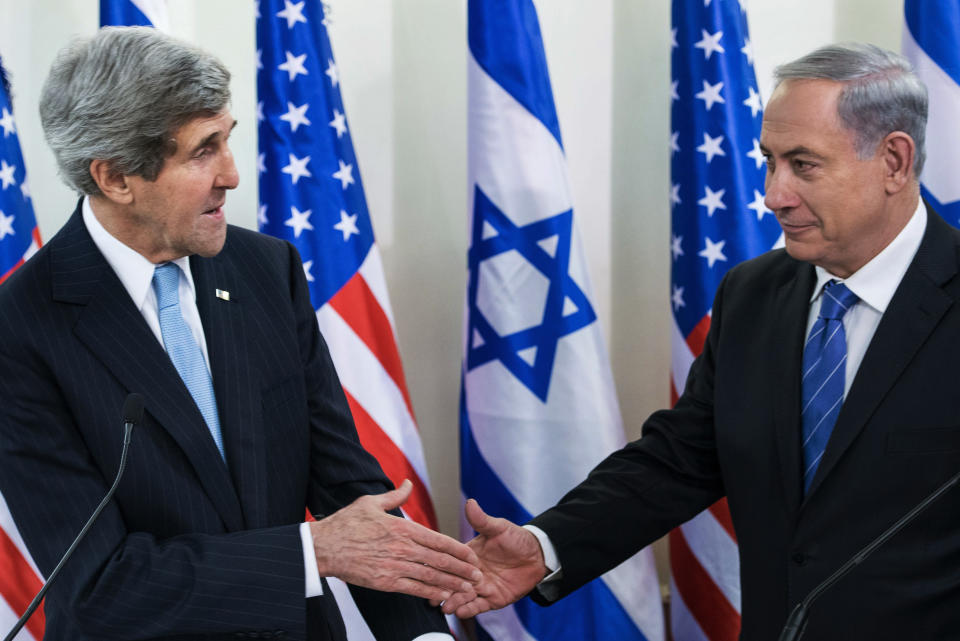 U.S. Secretary of State John Kerry, left, and Israeli Prime Minister Benjamin Netanyahu shake hands before a meeting at the prime minister's office in Jerusalem, Thursday, Jan. 2, 2014. Kerry arrived Thursday in Israel to broker Mideast peace talks that are entering a difficult phase aimed at reaching a two-state solution between the Israelis and Palestinians. (AP Photo/Brendan Smialowski, Pool)