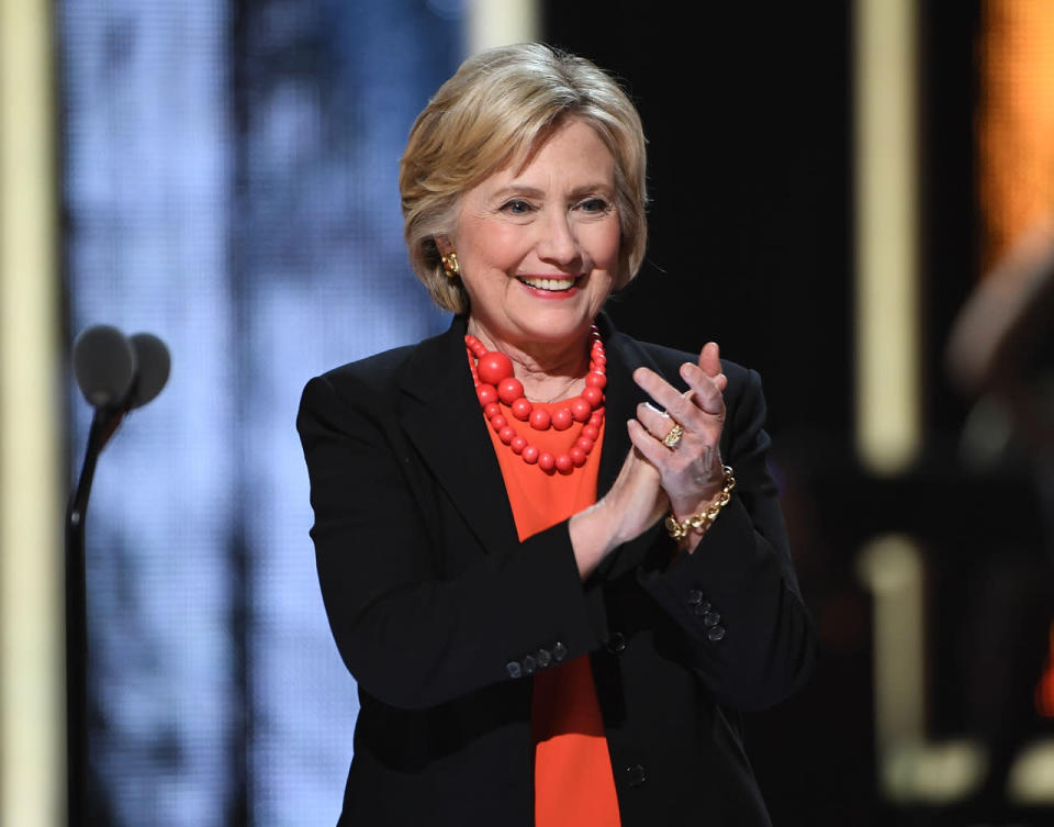 Hillary Clinton in a red blouse and matching baubles 