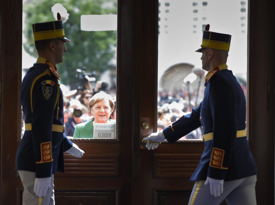 German Chancellor Angela Merkel, center, waits for a door to be opened as she arrives for an EU summit in Sibiu, Romania, Thursday, May 9, 2019. European Union leaders on Thursday start to set out a course for increased political cooperation in the wake of the impending departure of the United Kingdom from the bloc. (AP Photo/Vadim Ghirda)