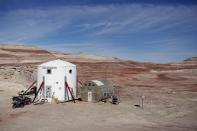 The Mars Desert Research Station (MDRS) is seen in the Utah desert March 2, 2013. The MDRS aims to investigate the possibility of a human exploration of Mars and uses the Utah desert's Mars-like terrain to simulate working conditions on the red planet. Scientists, students and enthusiasts work together to develop field tactics and study the terrain while wearing simulated spacesuits and carrying air supply packs. They live together in a small communication base with limited space and supplies. Picture taken March 2, 2013. REUTERS/Jim Urquhart