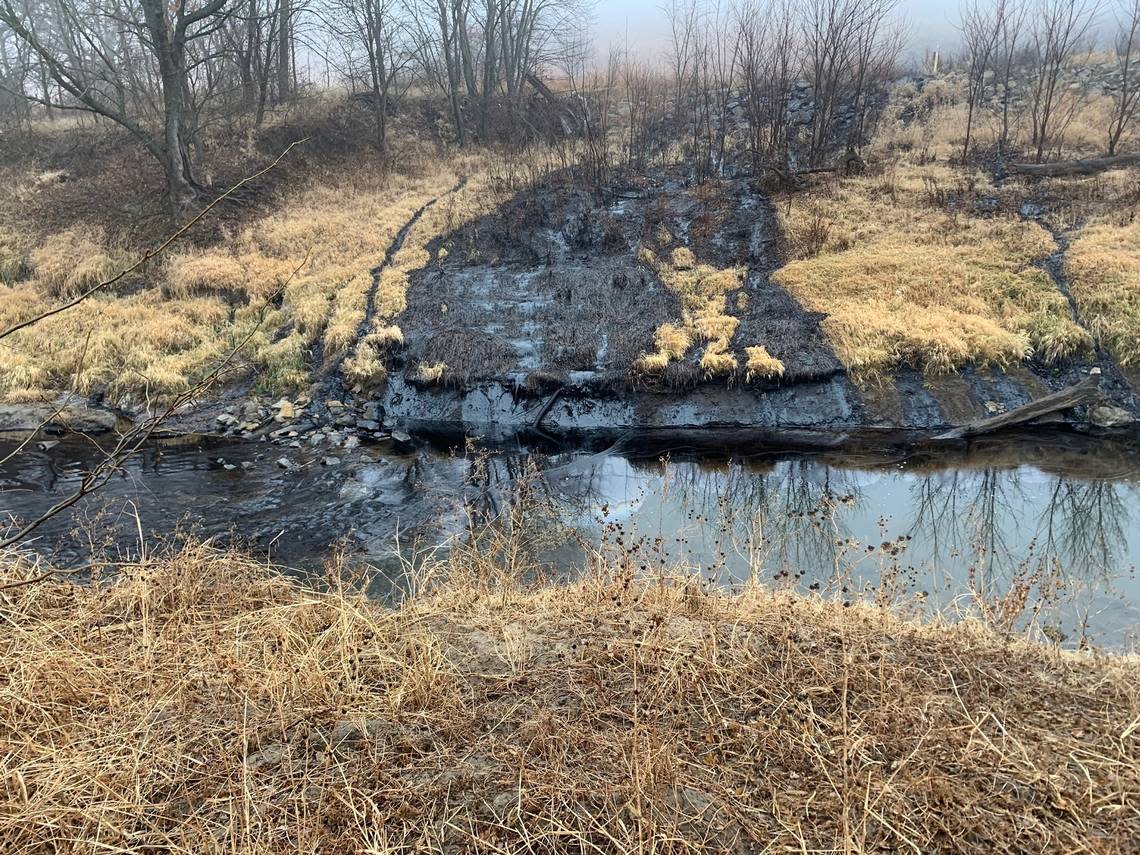 This photo by the U.S. Environmental Protection Agency shows oil from the recent Keystone Pipeline spill seeping into Mill Creek, a small tributary of the Kansas River, in northern Kansas on Friday, Dec. 9.