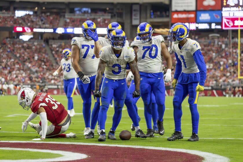 Running back (3) Cam Akers of the Los Angeles Rams celebrates with teammates after running the ball for a touchdown