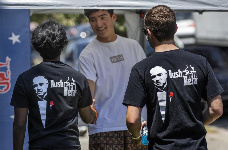 Young men shake hands