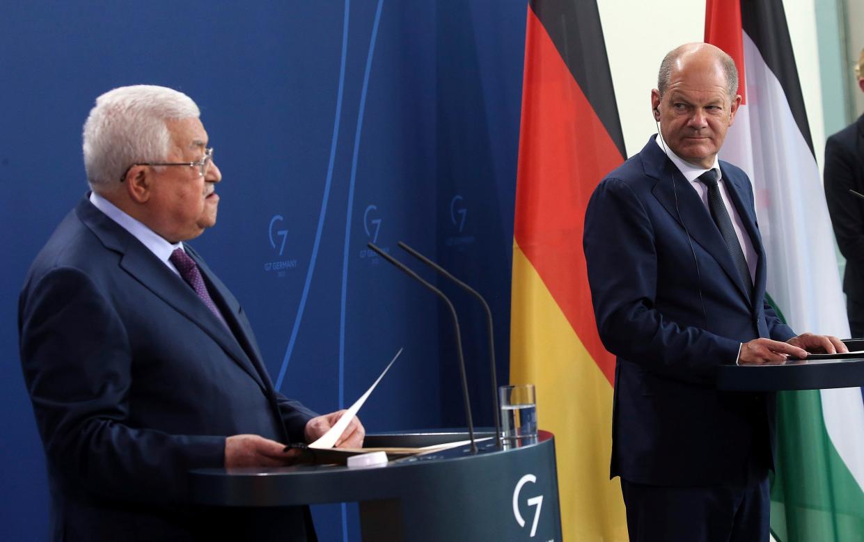 Mahmoud Abbas, left, speaks during a news conference after a meeting with Chancellor Olaf Scholz in Berlin on Wednesday - Wolfgang Kumm 