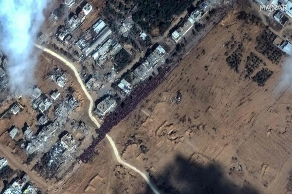 This handout satellite picture released by Maxar Technologies on Nov. 17, 2023, shows a crowd of people fleeing toward the southern part of the Gaza Strip, gathered along the Salah Al-Din road, as battles between Israel and Palestinian Hamas militants continue.
