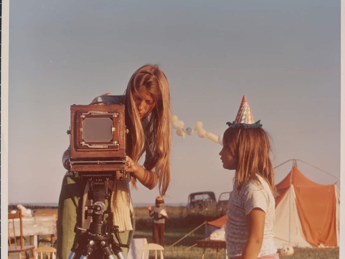 Melinda Blauvelt is shown setting up her camera at a birthday party in Brantville, now part of Tracadie. (Submitted by Melinda Blauvelt/Chad Floyd - image credit)