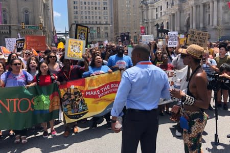 Activists protest President Donald Trump’s immigration policy as they march in Philadelphia