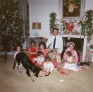 <p>President Kennedy poses in a candid family photo with his wife, children, dogs, and in-laws on what would be his last Christmas. </p>