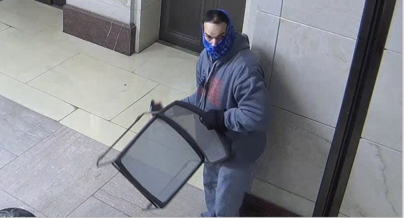 Jamie Buteau, as depicted by CCTV video, while in the elevator lobby next to the Crypt, picks up a chair as doors roll down to block the Crypt off from the CVC.