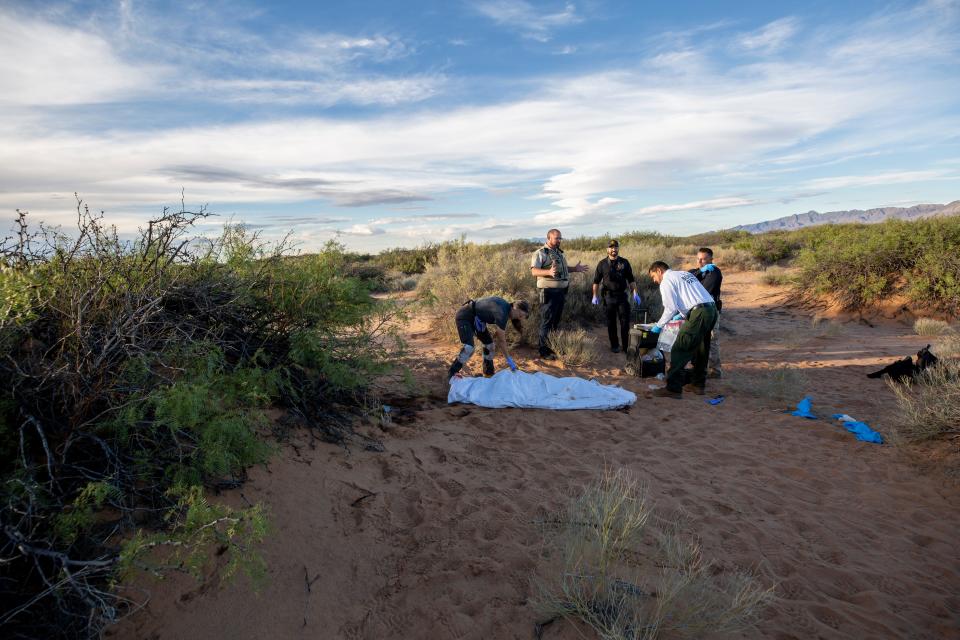 Laura Mae Williams, a field investigator for New Mexico's Office of the Medical Investigator, closes a body bag after examining the death of a migrant in the desert in New Mexico about two miles north of the U.S.-Mexico boundary on Sept. 13, 2023.