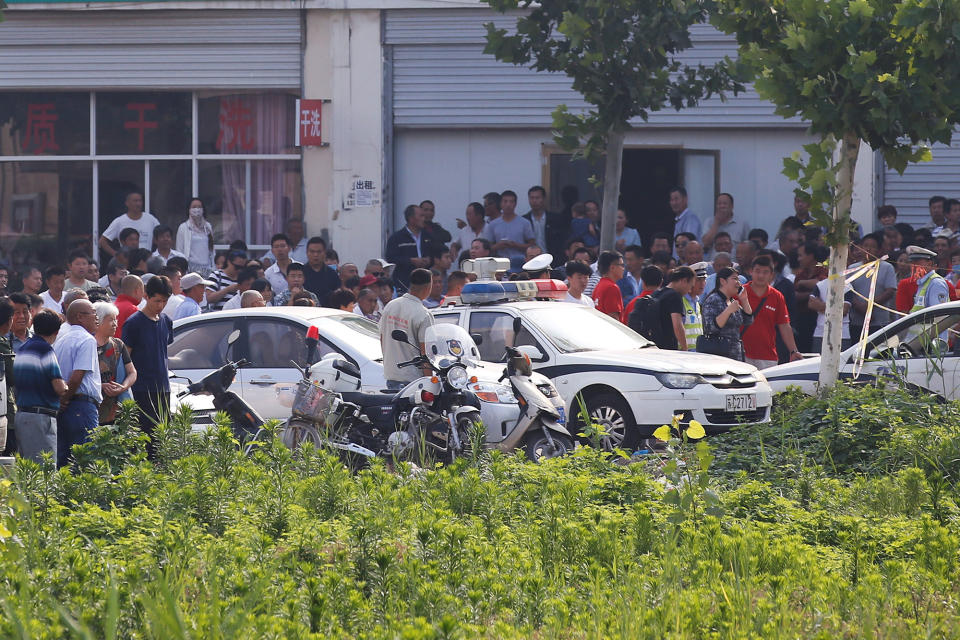 Onlookers and security personnel gather