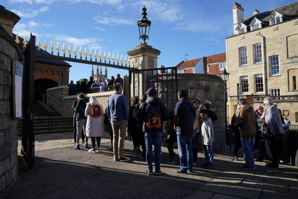 People queue outside as Windsor Castle and St George's Chapel, which is reopened to public for first time since Queen Elizabeth II's death, in Windsor, England, Thursday, Sept. 29, 2022. (Jonathan Brady/PA via AP)