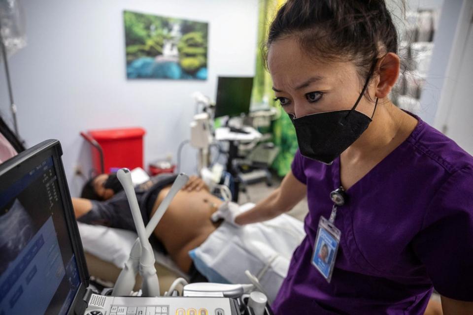 Dr Tien performs an ultrasound on MC, who is in her second trimester, at Planned Parenthood in Jacksonville (Reuters)