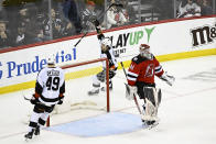 New Jersey Devils goaltender Vitek Vanecek (41) reacts as Philadelphia Flyers right wing Travis Konecny (11) celebrates his goal with left wing Noah Cates (49) during the third period of an NHL hockey game Thursday, Dec.15, 2022, in Newark, N.J. The Flyers defeated the Devils 2-1. (AP Photo/Bill Kostroun)