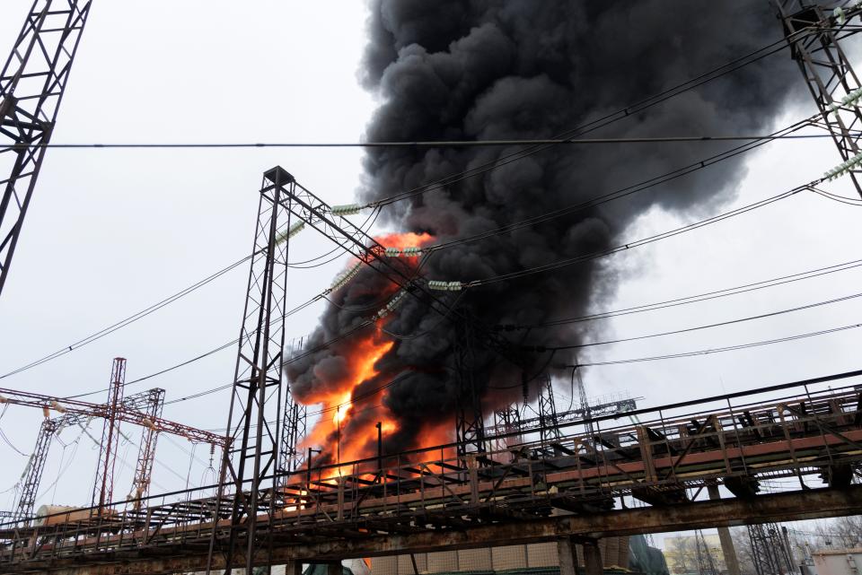 Flames and smoke rise from a blaze at an electricity facility after a Russian attack in Kharkiv, Ukraine on 22 March (AP)