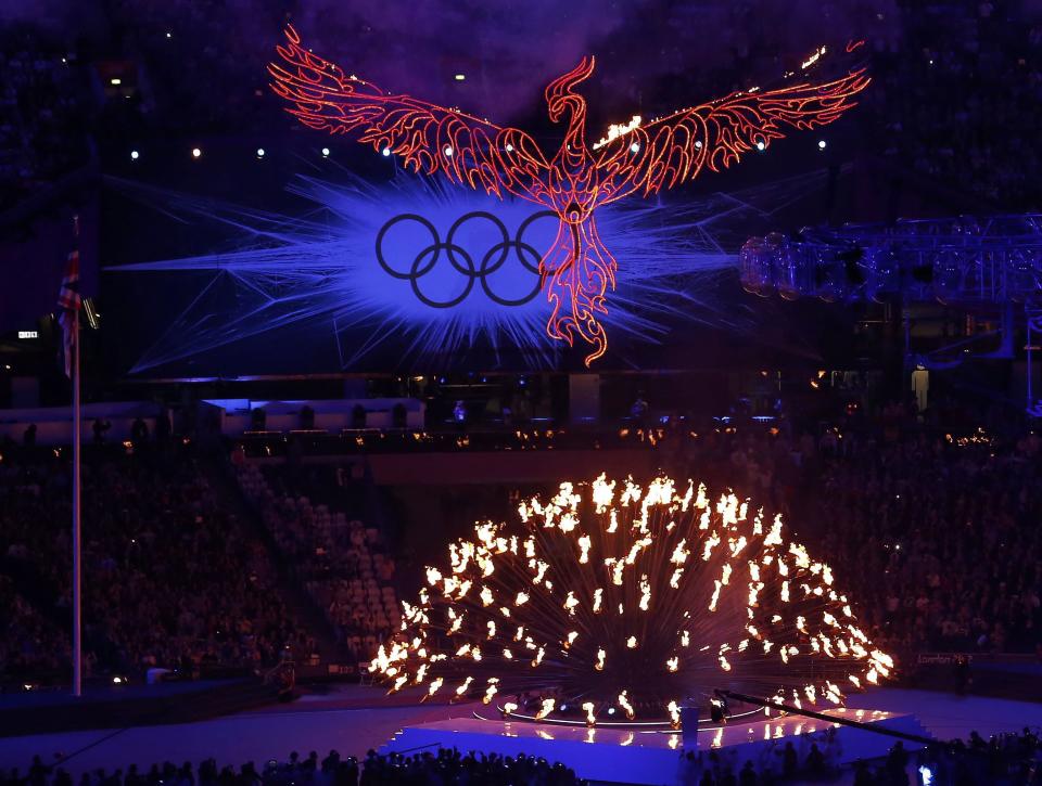 A flaming phoenix flies above the Olympic flame during the closing ceremony of the London 2012 Olympic Games at the Olympic Stadium August 12, 2012. REUTERS/Luke Macgregor (BRITAIN - Tags: OLYMPICS SPORT TPX IMAGES OF THE DAY) 