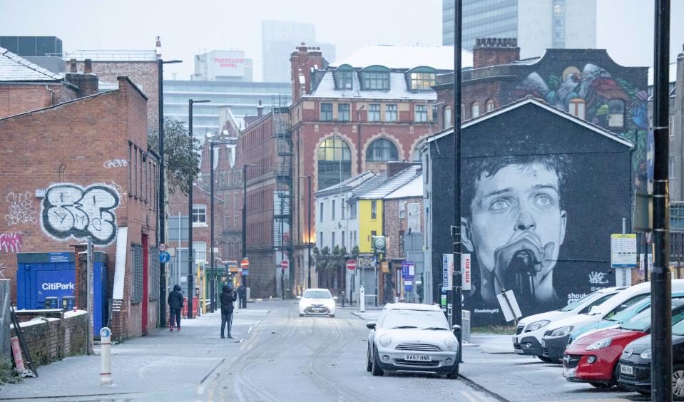 A mural of Joy Division's Ian Curtis watches over the Northern Quarter in Manchester city centre, as snow hits the UK. Tuesday 29th December 2020.  (Photo by Pat Scaasi/MI News/NurPhoto via Getty Images)