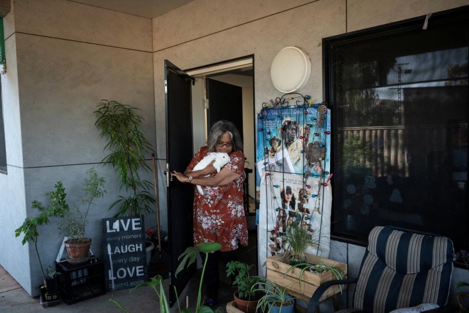 Artist Kathy Coulthard, who is Indigenous, walks onto the back porch of her home in Alice Springs (Reuters)