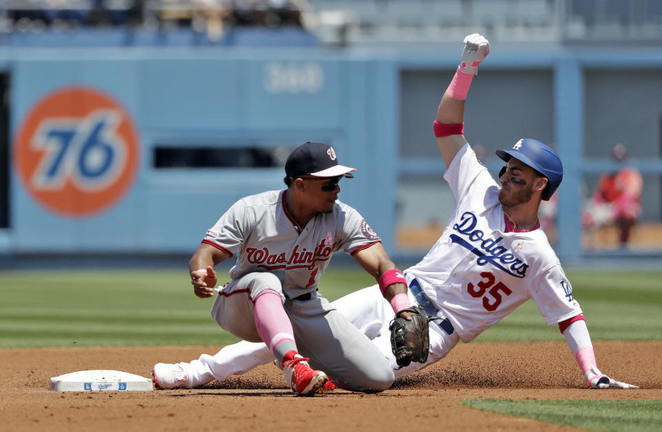 Los Angeles Dodgers' Cody Bellinger (35) steals second base past Washington Nationals shortstop Wilmer Difo during the second inning of a baseball game Sunday, May 12, 2019, in Los Angeles. (AP Photo/Marcio Jose Sanchez)
