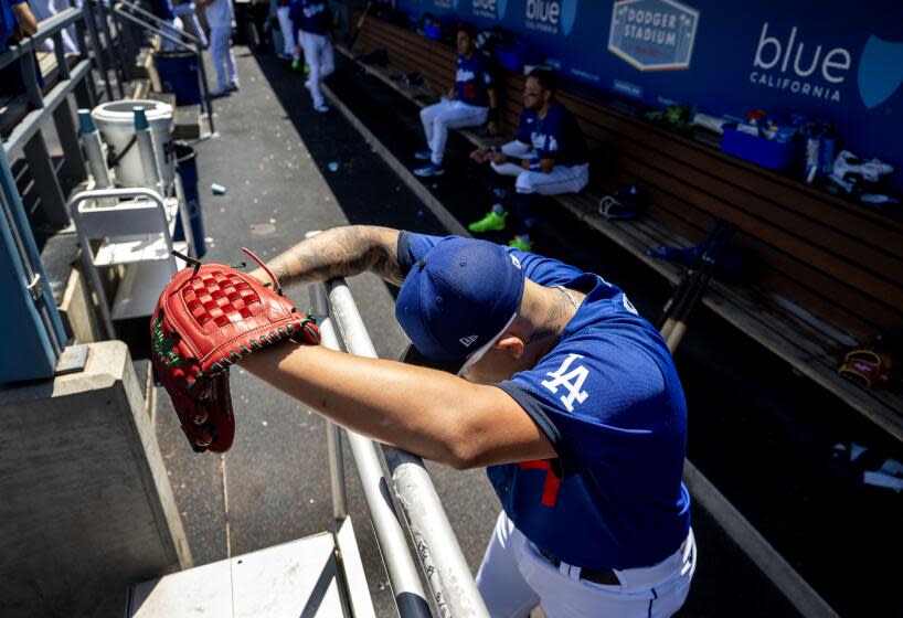 LOS ANGELES, CA - AUGUST 13, 2023: Los Angeles Dodgers starting pitcher Julio Urias (7) stares down at the ground in the dugout by himself in between innings against the Colorado Rockies at Dodger Stadium on August 13, 2023 in Los Angeles, CA. Urias had 12 strike outs. (Gina Ferazzi / Los Angeles Times)