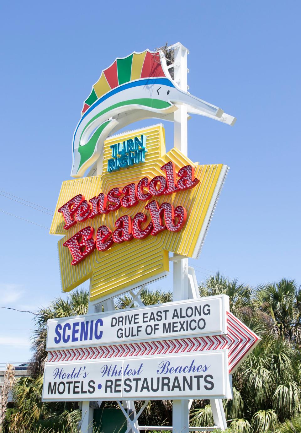 A pair of osprey have built a nest atop the Pensacola Beach sign in Gulf Breeze on Thursday, April 2, 2020.