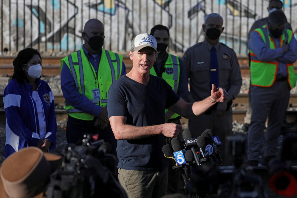 California Governor Gavin Newsom visits the site where multiple train looting has occurred along the freight train tracks in Los Angeles, California U.S., January 20, 2022 . REUTERS/David Swanson
