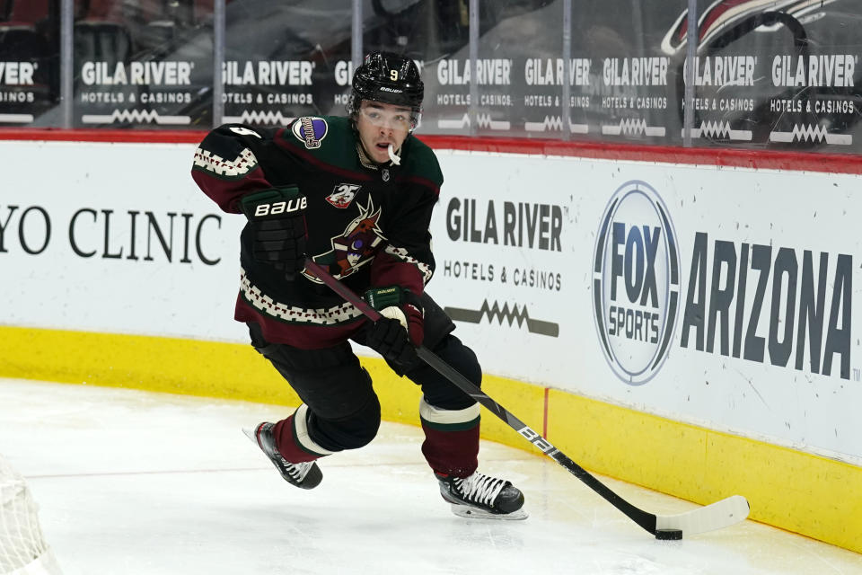 FILE - In this March 23, 2021, file photo, Arizona Coyotes right wing Clayton Keller (9) skates with the pick in the first period during an NHL hockey game against the Colorado Avalanche in Glendale, Ariz. (AP Photo/Rick Scuteri, File)