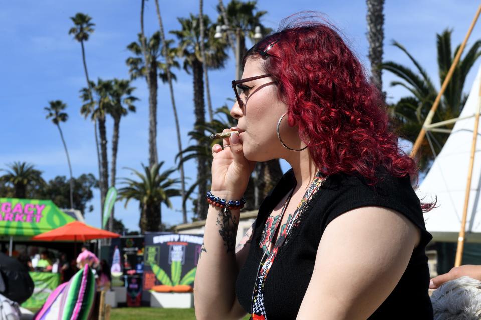 Veronica Romero enjoys a smoke in the consumption lounge area during the Hall of Flowers cannabis industry trade show at the Ventura County Fairgrounds on Wednesday.