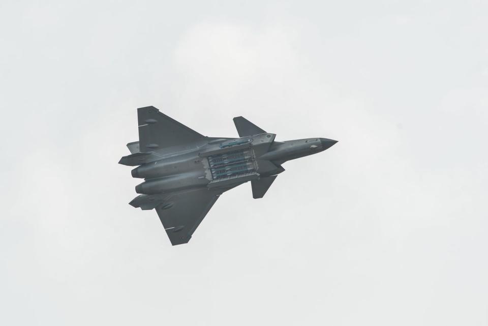 chengdu j 20 fighter with weapons bay open showing air to air missiles inside