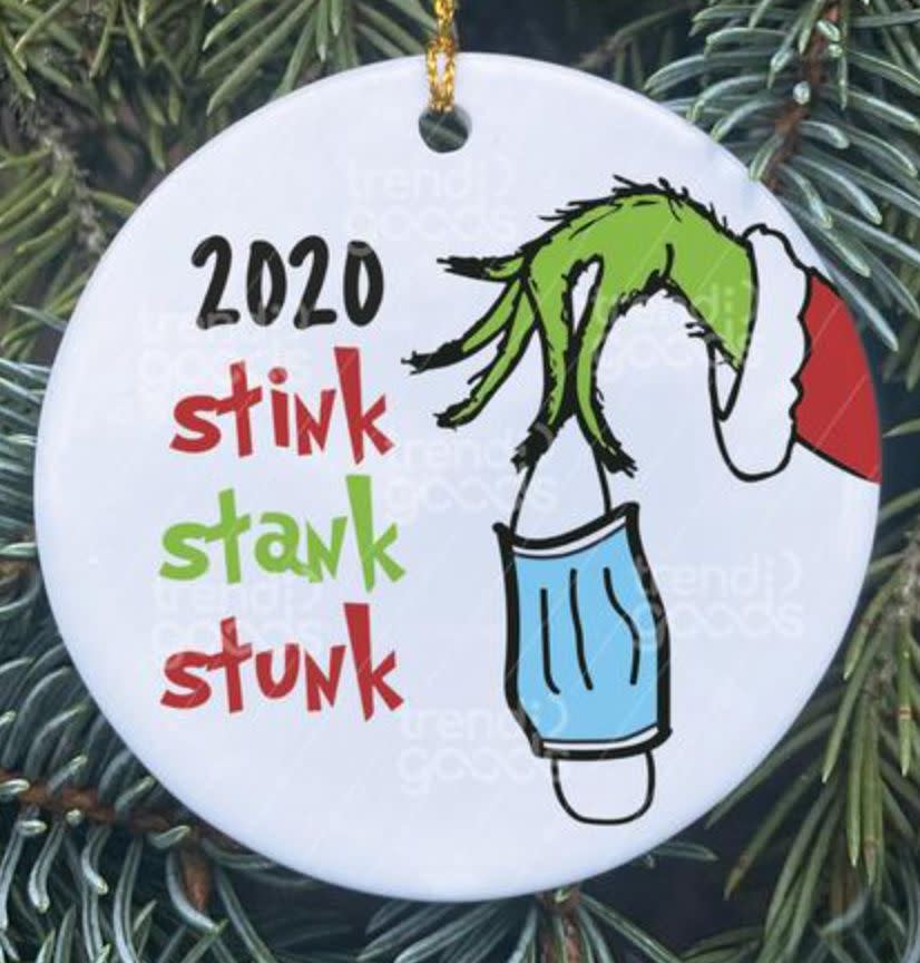 (Photo: <a href="https://www.etsy.com/listing/863025490/grinch-hand-christmas-ornament-covid?ga_order=most_relevant&ga_search_type=all&ga_view_type=gallery&ga_search_query=mask+ornament&ref=sr_gallery-1-9&organic_search_click=1&bes=1" target="_blank">TrendiGoodsCo</a>)