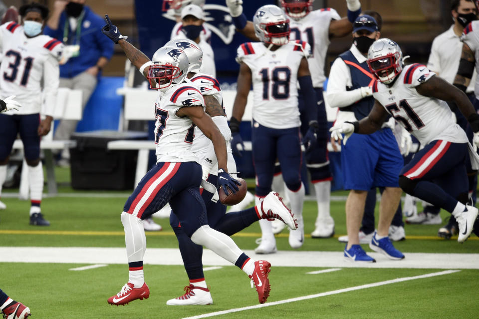 New England Patriots cornerback J.C. Jackson, left, runs back with an intercepted pass during the second half of an NFL football game against the Los Angeles Chargers Sunday, Dec. 6, 2020, in Inglewood, Calif. (AP Photo/Kelvin Kuo)
