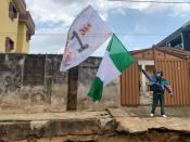 Adebanjo Akinwunmi raises his flags as Nigeria marks the one anniversary of the EndSARS anti-police brutality protests in Lagos