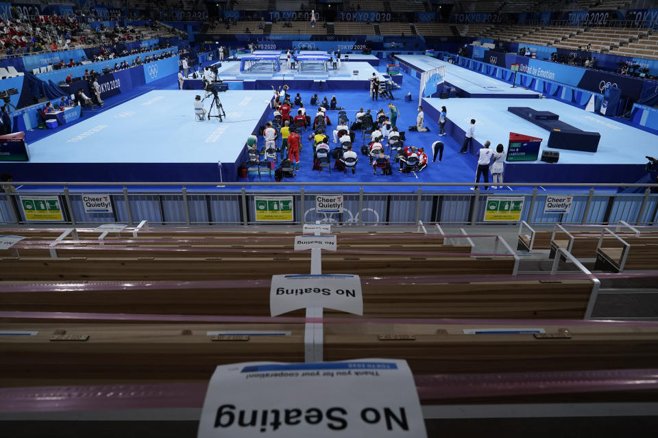 A sign designating a closed seating area is taped to a seat during the women's trampoline gymnastics qualifier at the 2020 Summer Olympics, Friday, July 30, 2021, in Tokyo, Japan. (AP Photo/Ashley Landis)