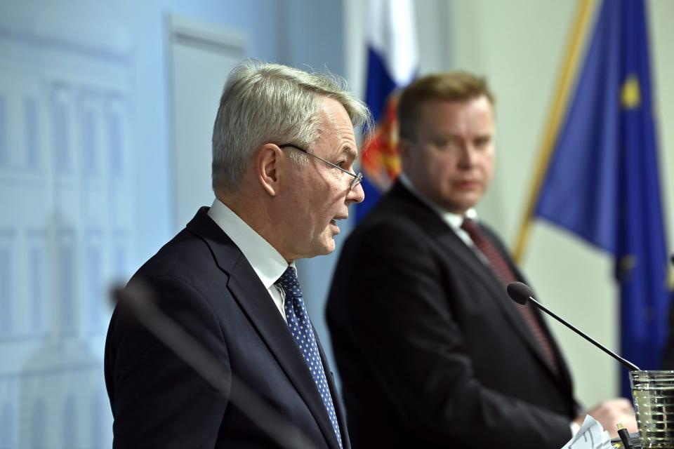 From left, Finland's Foreign Minister Pekka Haavisto and Defence Minister Antti Kaikkonen present the report on changes in the foreign and security policy environment of Finland after Russia's attack to Ukraine in Helsinki, Finland, Wednesday, April 13, 2022. (Markku Ulander/Lehtikuva via AP)