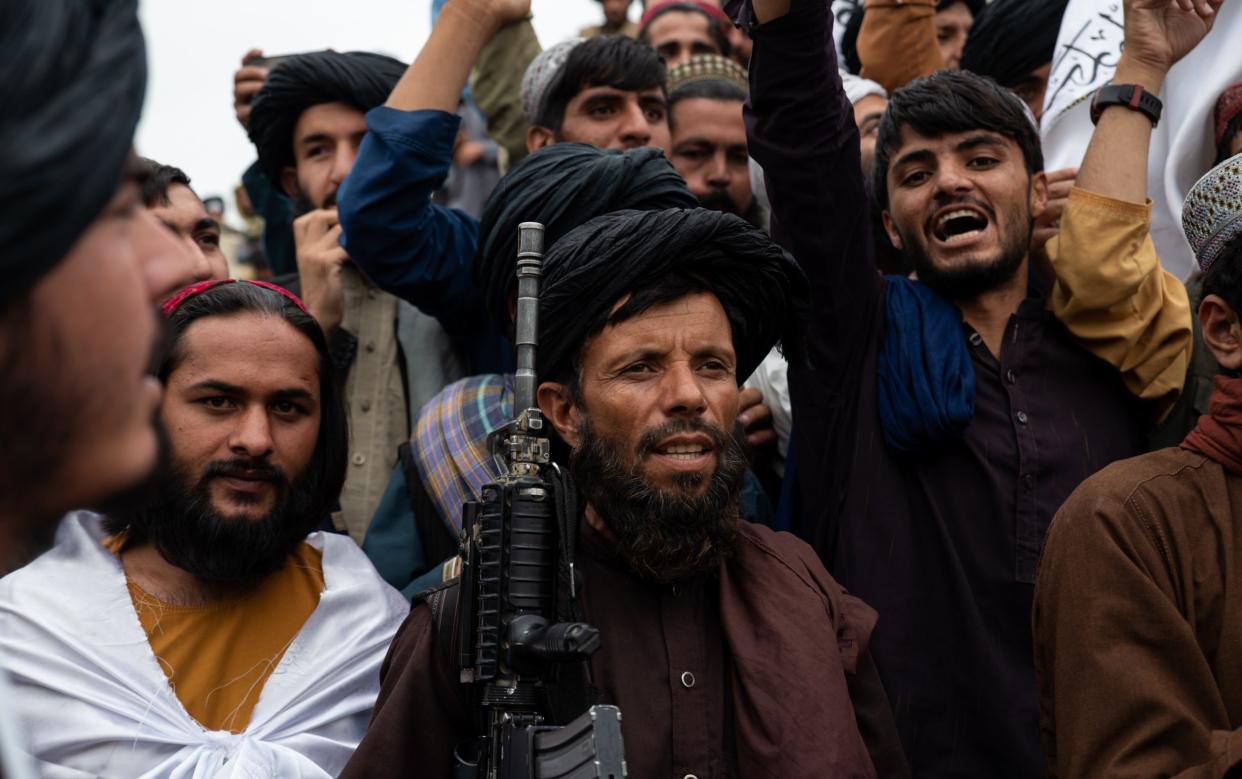 Men celebrate the first anniversary of the Taliban's return to power in Kabul, Afghanistan - Nava Jamshidi/Getty Images