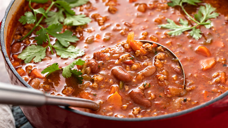 homemade chili in pot with ladle