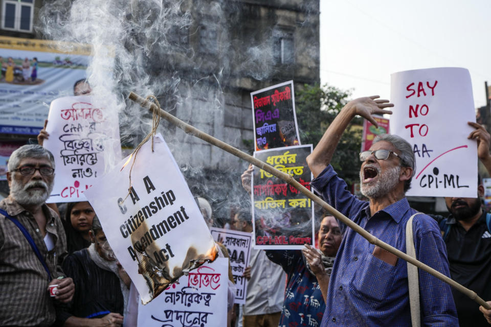 Activists and supporters of Communist Party of India (Marxist-Leninist) burn a copy of the the Citizenship Amendment Act (CAA) during a protest against CAA in Kolkata, India, Tuesday, March 12, 2024. India has implemented a controversial citizenship law that has been widely criticized for excluding Muslims, a minority community whose concerns have heightened under Prime Minister Narendra Modi's Hindu nationalist government. The act provides a fast track to naturalization for Hindus, Parsis, Sikhs, Buddhists, Jains and Christians who fled to Hindu-majority India from Afghanistan, Bangladesh and Pakistan before Dec. 31, 2014. (AP Photo/Bikas Das)