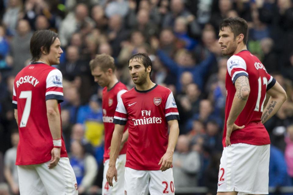 Arsenal's Mathieu Flamini, centre, stands amongst teammates as they wait for play to restart after Everton's second goal during their English Premier League soccer match at Goodison Park Stadium, Liverpool, England, Sunday April 6, 2014. (AP Photo/Jon Super)
