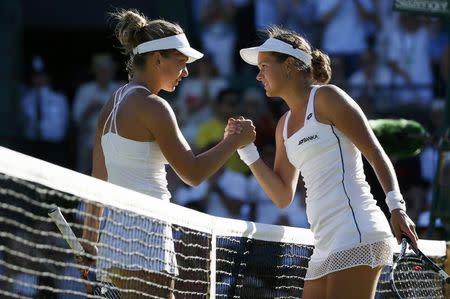 Jana Cepelova of Slovakia shakes hands with Simona Halep of Romania after winning their match at the Wimbledon Tennis Championships in London, June 30, 2015. REUTERS/Stefan Wermuth