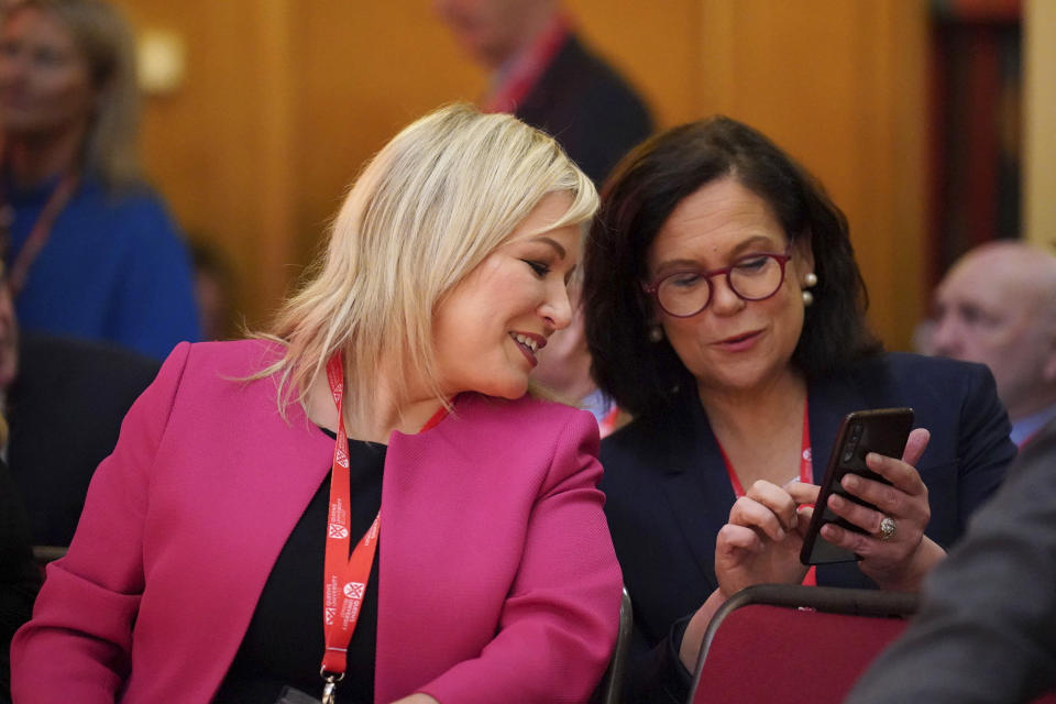 Sinn Fein vice president Michelle O'Neill, left, and party leader Mary Lou McDonald, attend the first day of a three-day international conference at Queen's University Belfast to mark the 25th anniversary of the Good Friday Agreement, in Belfast, Northern Ireland, Monday, April 17, 2023. Former U.S. President Bill Clinton and past leaders of the U.K. and Ireland are gathering in Belfast on Monday, 25 years after their charm, clout and determination helped Northern Ireland strike a historic peace accord. (Niall Carson/PA via AP)