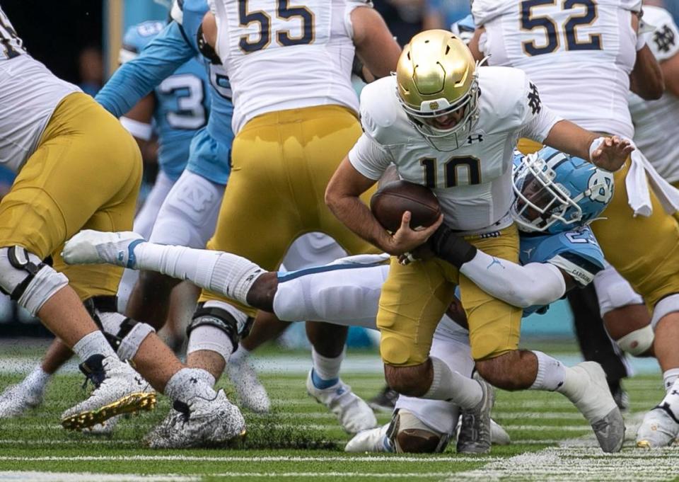 North Carolina’s Power Echols (23) sacks Notre Dame quarterback Drew Pyne (10) in the first quarter on Saturday, September 24, 2022 at Kenan Stadium in Chapel Hill, N.C.