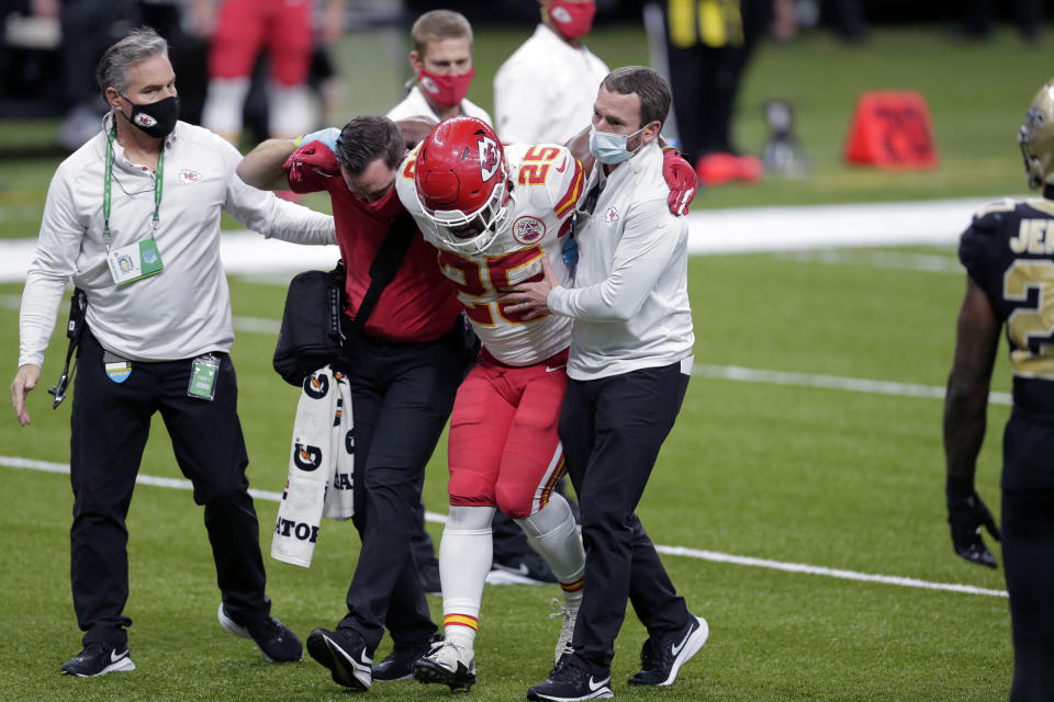 Kansas City Chiefs running back Clyde Edwards-Helaire (25) is helped off the field after being injured in the second half of an NFL football game against the New Orleans Saints in New Orleans, Sunday, Dec. 20, 2020. (AP Photo/Brett Duke)