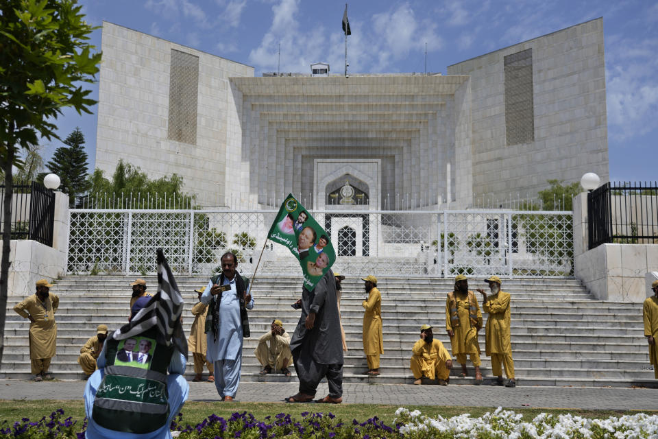 Supporters of Pakistan Democratic Movement, an alliance of the ruling political parties, gather to attend a rally outside the Supreme Court in Islamabad, Pakistan, Monday, May 15, 2023. Convoys of buses and vehicles filled with Pakistani pro-government supporters are flooding the main road leading to the country's capital on Monday to protest the release of former Prime Minister Imran Khan. (AP Photo/Anjum Naveed)