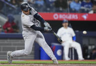New York Yankees' Jose Trevino hits an RBI single against the Toronto Blue Jays during the second inning of a baseball game in Toronto on Tuesday, April 16, 2024. (Nathan Denette/The Canadian Press via AP)