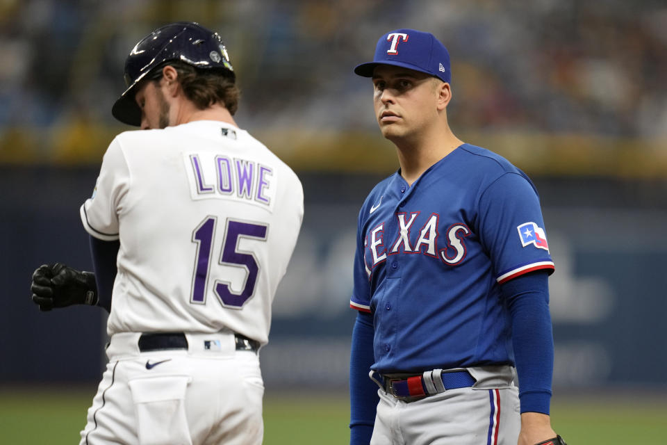 Josh, left, and Nathaniel Lowe are playing each other in this postseason's wild-card round. (AP Photo/John Raoux)