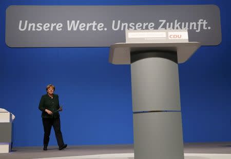 German Chancellor and leader of the conservative Christian Democratic Union party CDU Angela Merkel walks before her closing speech of the CDU party convention in Essen, Germany, December 7, 2016. REUTERS/Wolfgang Rattay