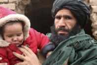 An Afghan man hold his injured daughter after his home was damaged by Monday's earthquake in the remote western province of Badghis, Afghanistan, Tuesday, Jan. 18, 2022. The United Nations on Tuesday raised the death toll from Monday's twin earthquakes in western Afghanistan, saying three villages of around 800 houses were flattened by the temblors. (Abdul Raziq Saddiqi)