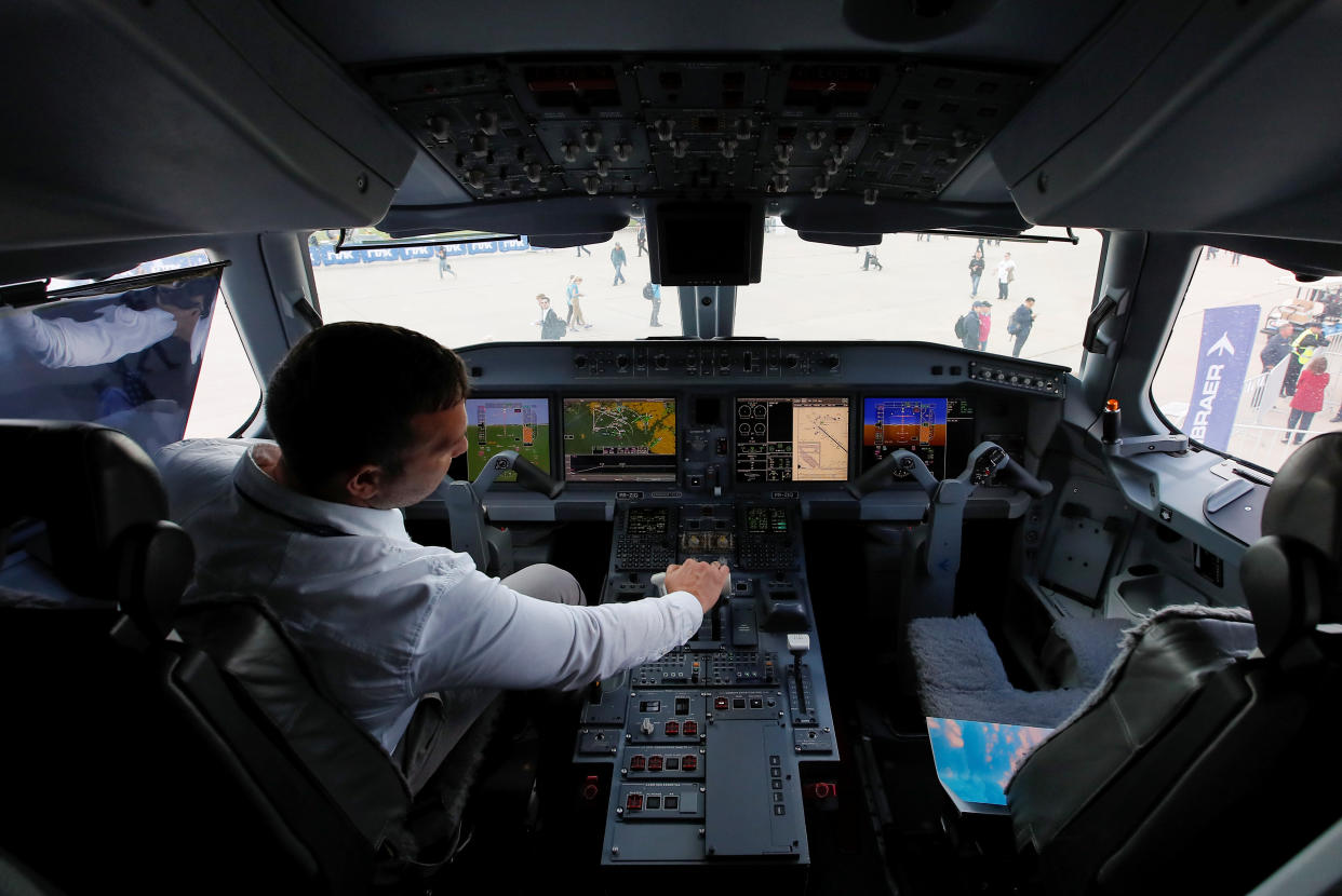 A pilot sits in a cockpit of the Embraer E-195 E2 jet airliner at the MAKS 2019 air show in Zhukovsky, outside Moscow, Russia, August 27, 2019.  REUTERS/Maxim Shemetov