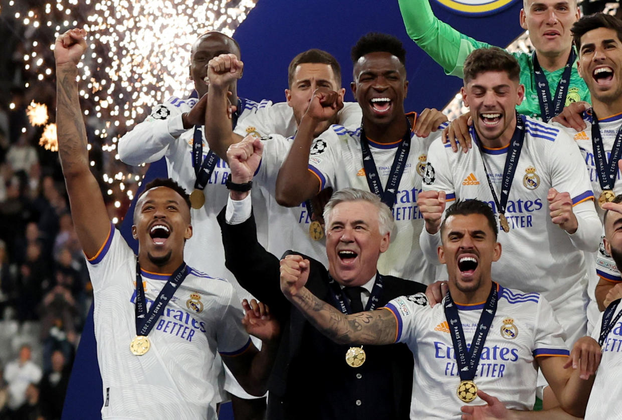 Soccer Football - Champions League Final - Liverpool v Real Madrid - Stade de France, Saint-Denis near Paris, France - May 28, 2022 Real Madrid's Ferland Mendy, Eden Hazard, Vinicius Junior, Federico Valverde, Marco Asensio, Eder Militao, coach Carlo Ancelotti and Dani Ceballos celebrate after winning the Champions League REUTERS/Lee Smith