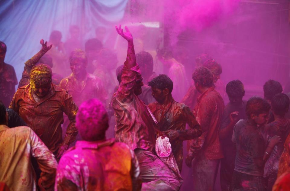 Hindu devotees play with colored powder during Holi festival celebrations in Hyderabad, India, Tuesday, March 26, 2013. Holi, the festival of colors celebrates the arrival of spring among other things. (AP Photo/Mahesh Kumar A.)